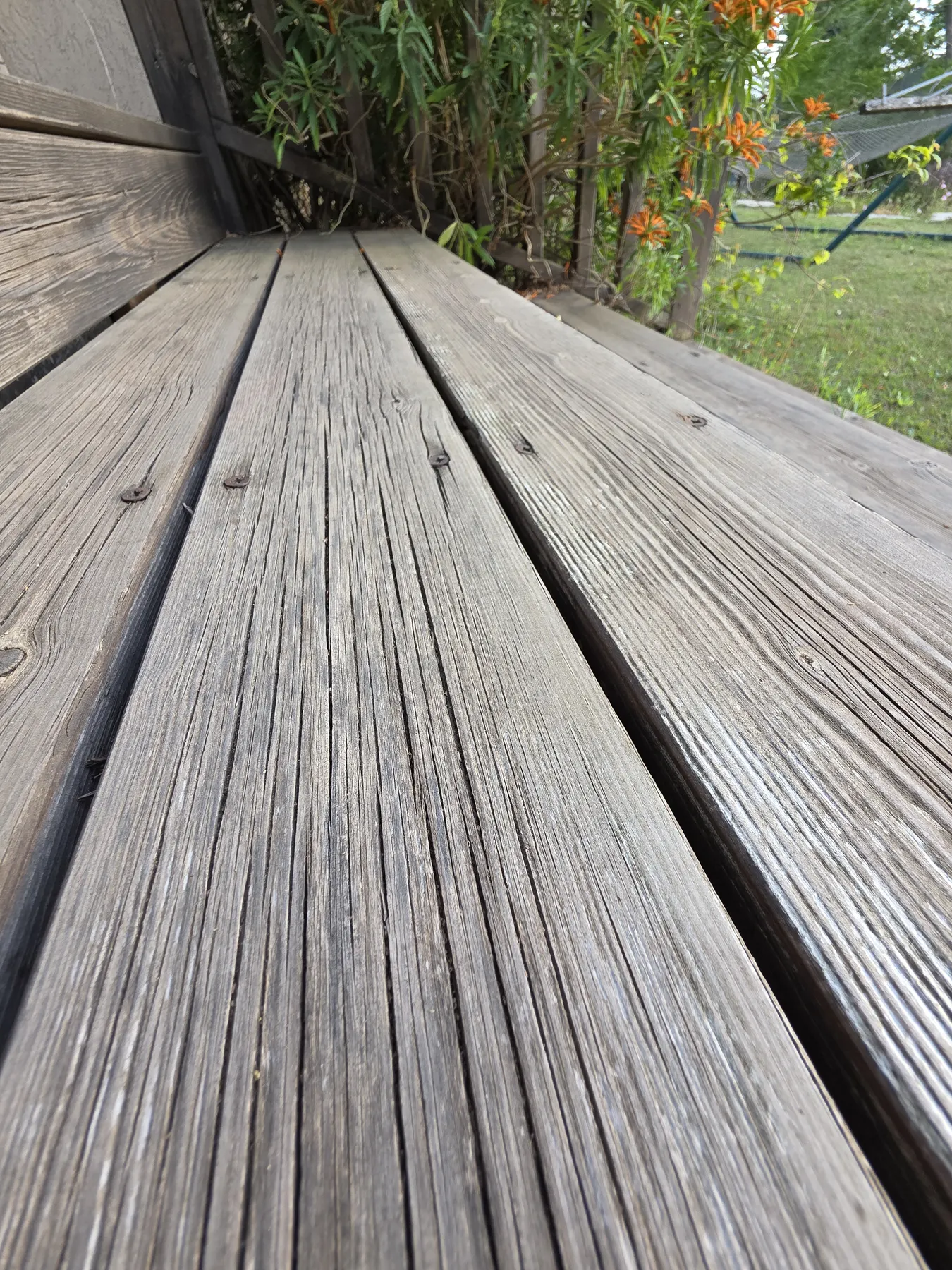 Close-up of cracked deck boards requiring oiling